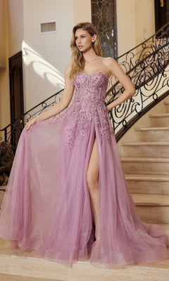 A woman stands on a staircase wearing the Nox Anabel G1371 strapless long prom ball gown in dark rose, featuring floral embellishments, glitter accents, and a high slit.