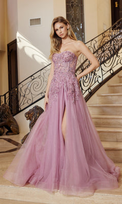 A woman stands on a staircase with ornate railing, wearing the Nox Anabel G1371 strapless long prom ball gown in lavender, featuring floral appliqués and a thigh-high slit.