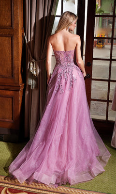 A woman is seen from behind indoors wearing the Nox Anabel G1371 Strapless Long Prom Ball Gown, featuring a floor-length pink tulle skirt and floral embroidery.