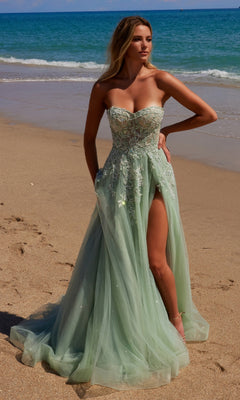 A woman in the Nox Anabel G1371 Strapless Long Prom Ball Gown poses gracefully on a sunlit beach.