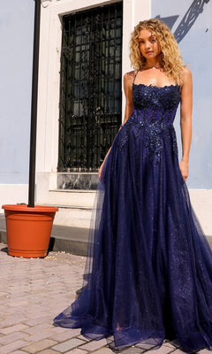 A woman wears the Embellished-Bodice Long A-Line Prom Dress G1405, standing on a paved area near a light blue building and a large empty plant pot.