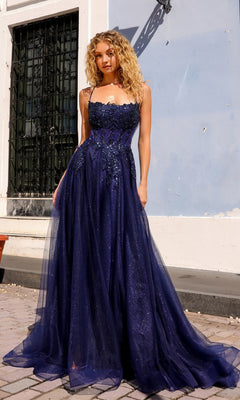 Outdoors, a woman wears the Embellished-Bodice Long A-Line Prom Dress G1405, a strapless, floor-length dark blue gown with tulle overlays and a sparkling bodice.