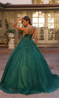 A woman stands outside in front of glass doors, wearing the Glitter-Tulle Long Prom Ball Gown H1271 with floral details and crisscross back straps.