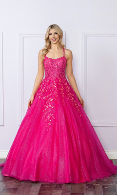 A woman in a Glitter-Tulle Long Prom Ball Gown H1271, featuring bright pink color and floral embellishments, stands before a light-colored paneled wall.