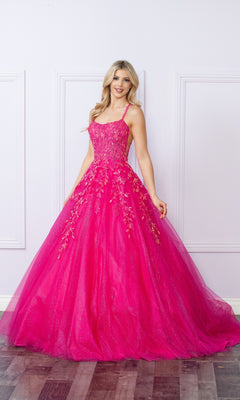 A woman poses indoors by a light-colored, white-paneled wall wearing the Glitter-Tulle Long Prom Ball Gown H1271, a bright pink dress with thin straps and delicate floral embroidery.