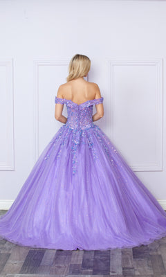 A woman faces away from the camera against a pale wall in the Bright Off-the-Shoulder Long Prom Ball Gown H1349, featuring a lavender hue, full tulle skirt, and floral embellishments.