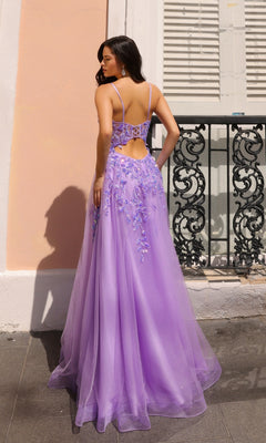 A woman stands outdoors in the Sheer-Corset Long Prom Ball Gown (Nox Anabel H1350), featuring a lavender hue, floral details, a corset-style cut-out back, and an elegant A-line silhouette, facing away from the camera.