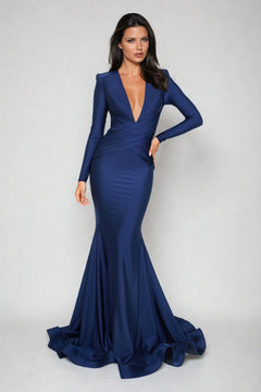 Woman wearing the Long-Sleeve Long V-Neck Prom Dress (6535H) from Atria Couture, in deep blue, featuring a V-neckline and long sleeves, standing against a plain light background.