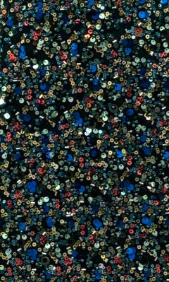 Close-up of densely packed blue, gold, and red sequins on a dark background, reminiscent of the Portia and Scarlett PS25615E Long Prom Dress—perfect for any formal evening event.