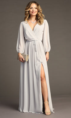 A woman in the Chicas J012B Long-Sleeve Long Formal Dress—a light gray gown with a wrap design and thigh-high slit—poses against a plain background, styled with heels, a clutch, and a necklace.