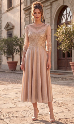 A woman stands outdoors in front of a building, wearing the Midi Wedding Guest Dress: Chicas J040 in champagne, which features sparkly lace details, sheer sleeves, and open-toe heels.
