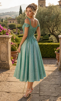 A woman wearing the Midi Wedding Guest Dress: Chicas J049—a sparkly teal off-shoulder dress featuring an embroidered bodice and a flowing A-line skirt—stands on a stone path in a formal garden, glancing over her shoulder.