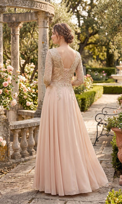 A woman wearing the Long Prom Dress: Chicas J070—a blush pink lace gown—stands in a garden with stone columns, roses, and lush greenery, her back to the camera. The dress’s elegant silhouette captures the timeless grace of a mother of the bride amidst this romantic setting.