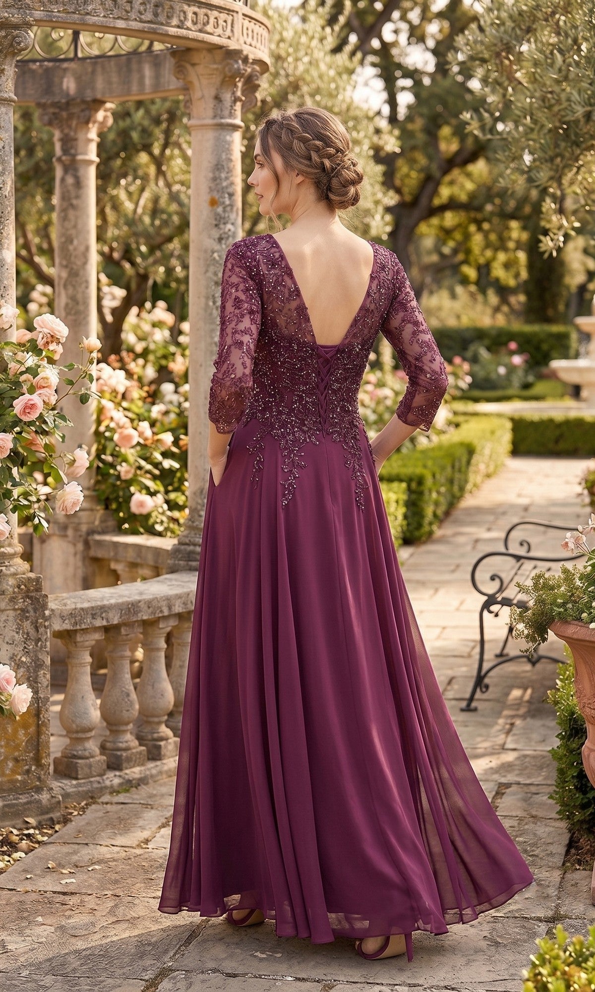 A woman in the Long Prom Dress: Chicas J070—a floor-length, purple chiffon evening gown with lace sleeves—stands outdoors on a stone path, surrounded by rose bushes and greenery, facing away from the camera.