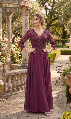 A woman wearing the Long Prom Dress: Chicas J070, a plum beaded chiffon evening gown with lace sleeves, stands in a garden surrounded by stone columns, blooming roses, and lush greenery.