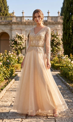 A woman stands outdoors in a garden wearing the Chicas J082 Long Prom Dress in champagne, featuring lace and bead details that accentuate the embellished bodice, creating an elegant look perfect for a stunning mother of the bride. Greenery and a stone building provide a picturesque backdrop.