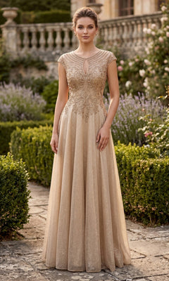 A woman stands outdoors in a garden wearing the Long Prom Dress: Chicas J132, a formal gown with a gold embellished bodice, elegant cap sleeves, a keyhole neckline, and a sparkling A-line skirt that flows gracefully to the floor.