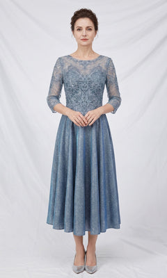 A woman wearing the Modest Midi Wedding Guest Dress: Chicas J152 in blue—a knee-length, lace A-line midi dress with three-quarter sleeves—stands against a plain white background, showcasing an elegant choice for wedding guests.
