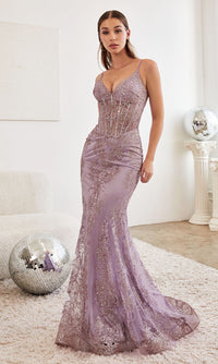 Woman modeling a light purple evening gown standing on a plush carpet with a white wall background and disco ball props.