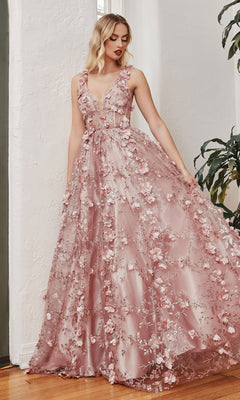 Woman wearing the Long Glitter-Floral A-Line Prom Ball Gown J838, a floor-length sleeveless evening dress with 3D floral embellishments, standing indoors near a potted plant.