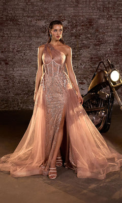 A woman in the Glitter-Print One-Shoulder Long Prom Dress J869 in Mocha Gold, featuring a thigh-high slit, stands by a motorcycle against a brick wall, her shimmering gown catching the light.