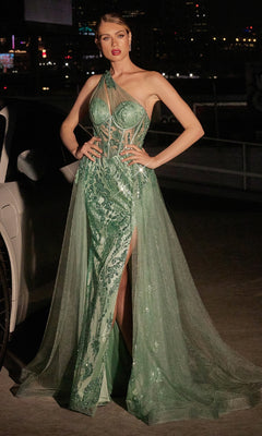 A woman stands outdoors at night wearing the Glitter-Print One-Shoulder Long Prom Dress J869—a chic green gown with sheer panels, sequin accents, and a thigh-high slit.