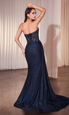 Woman in the Ladivine J875 Strapless Long Glitter Prom Dress with a sheer corset back and sequin details stands facing away in front of light-colored curtains.