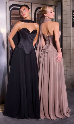 Two women in evening gowns stand on a subway platform; one wears the Ladivine J891, a long prom dress featuring elegant draping and a lace-up back, while the other dons a black corset bodice dress.
