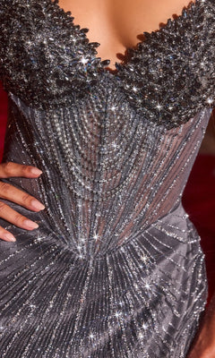 Close-up of a person confidently wearing the Ladivine J903 long prom dress, featuring silver sparkle, crystal bead embellishments, intricate patterns, and a boned corset bodice with one hand on their hip.