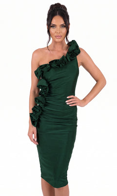 A woman wearing the Jessica Angel JA2505 short homecoming dress in Hunter—a fitted, one-shoulder cocktail dress with ruffle flower details along the neckline and side—stands against a plain white background.