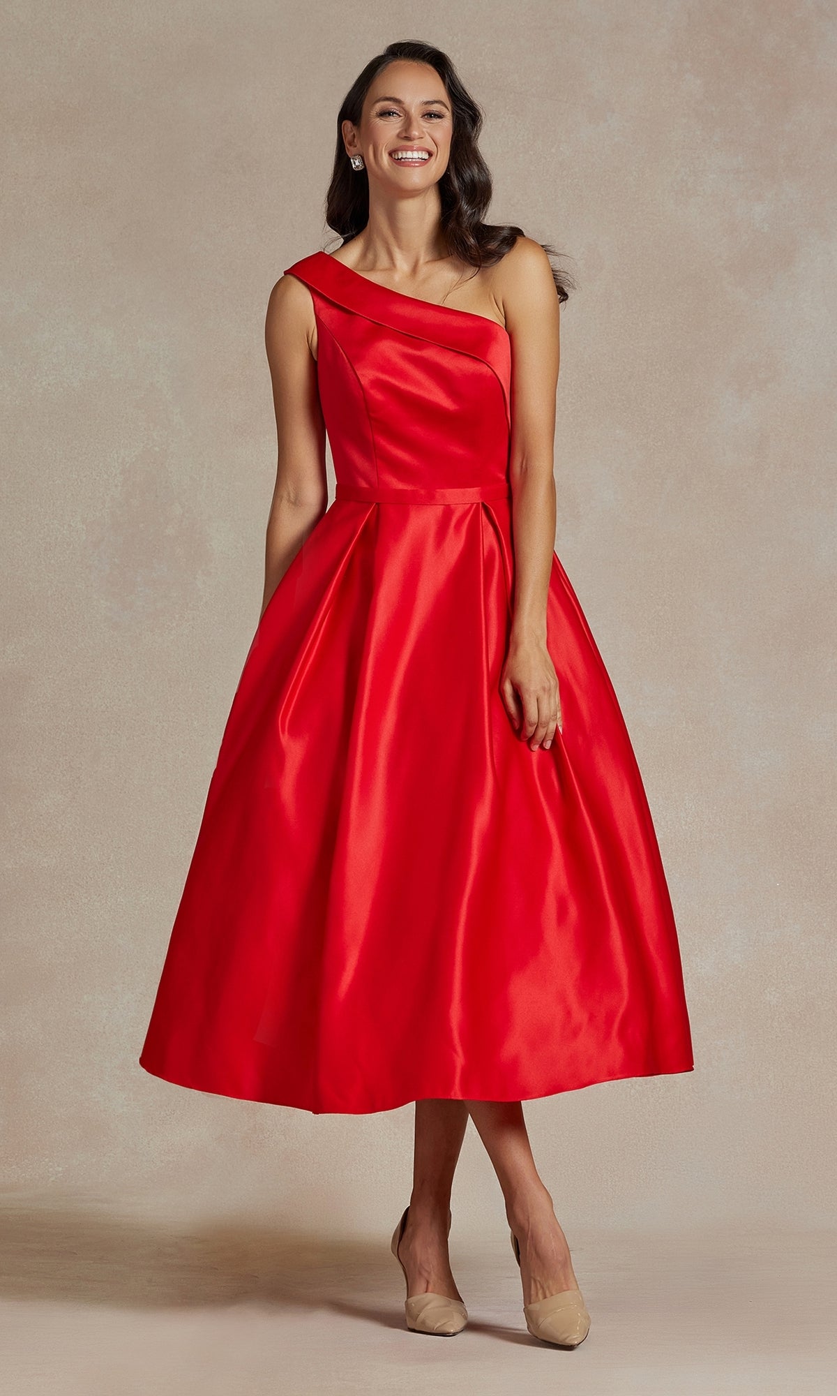 A woman wears the One-Shoulder Simple Tea-Length Party Dress JE931 in red with a full skirt and nude heels, posing against a neutral background.