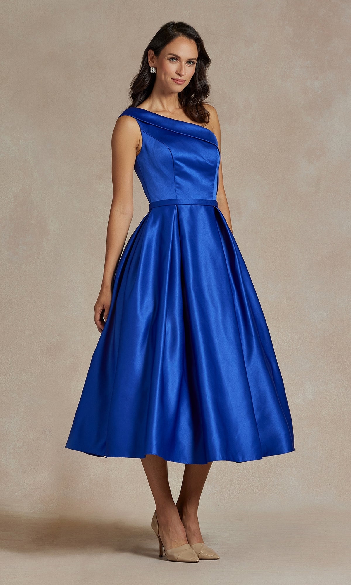 Woman wears One-Shoulder Simple Tea-Length Party Dress JE931 in royal blue with an asymmetric neckline and beige heels, standing against a neutral background.