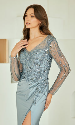 Woman wearing a grey evening gown with sheer sleeves and intricate detailing.