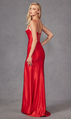 A woman in the Embellished-Corset Long Prom Dress: Juliet JT2434A—long, fitted red gown with a corset-style bodice and lace-up back—stands in profile against a plain gray background.