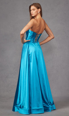 A woman models the Strapless Long Blue Prom Dress: Juliet JT2435A, featuring a sweetheart neckline, floor-length turquoise satin, and lace-up back, standing against a gray backdrop.
