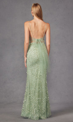 A woman faces away, wearing the Long Prom Dress JT2437A by Juliet in sage green, featuring a plunging v-neckline, backless design, thin straps, and floral embellishments, set against a plain gray background.