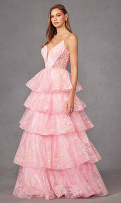 A woman poses in the Long Prom Dress JT2438K by Juliet, featuring a sleeveless deep V neckline, lace details, and tiered ruffle tulle layers, set against a plain gray background.