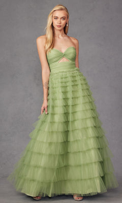 A woman in the Long Prom Dress JT2456H by Juliet, featuring a strapless light green tulle design with an empire waist, ruffle layers, and a midriff cutout, stands against a plain grey background.