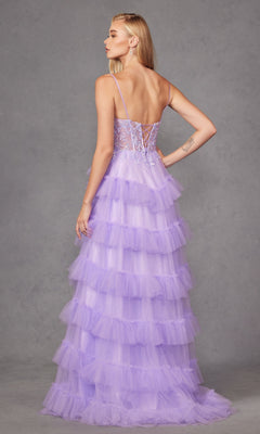 A woman faces away in the Long Prom Dress JT2459A by Juliet, a pastel purple ruffle tulle ball gown with thin straps and lace-up back, set against a plain gray background.