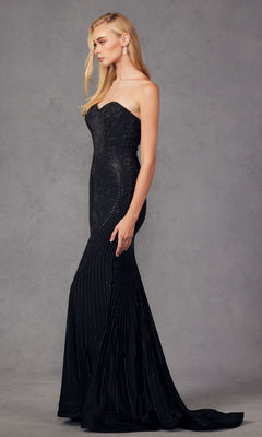 A woman stands in profile against a plain gray background, wearing the Juliet JT2472R strapless long sequin prom dress featuring subtle shimmering patterns.