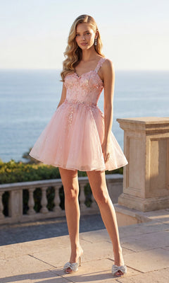 A woman stands outdoors by a stone railing, wearing the Short Pastel A-Line Hoco Dress: Juliet JT976L with beaded floral embellishments and silver heels. The sea and sky form the backdrop.