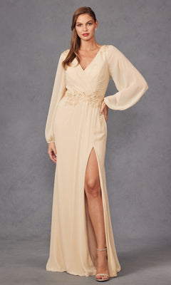 A woman models the Juliet JTM16A V-Neck Long Sleeve Prom Gown with sheer sleeves, floral embroidery at the waist, and a thigh-high slit against a gray background.