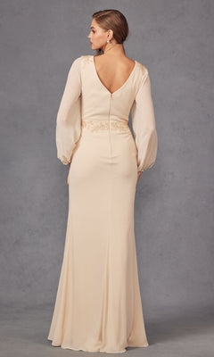 A woman stands facing away in the Juliet JTM16A V-Neck Long Sleeve Prom Gown, showcasing its deep V-shaped back and light beige color against a plain gray background.