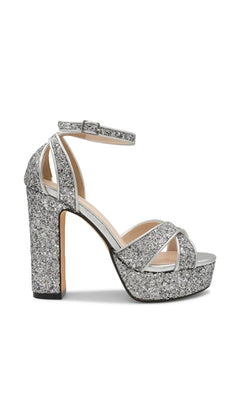 Jemma Silver Platform Prom Shoes: Touch Ups 4702 are silver glitter platform high-heeled sandals with a buckled ankle strap and crisscross front straps.
