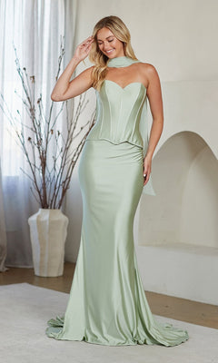 A woman wearing the Amelia Couture JQ1105 long prom dress in light green satin with a strapless sweetheart neckline and fitted bodice stands indoors beside a vase with branches.