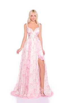 A woman wearing the Open-Back Pink Floral Maxi Dress: Juliette, featuring ruffled layers and a thigh-high slit, stands against a white background.
