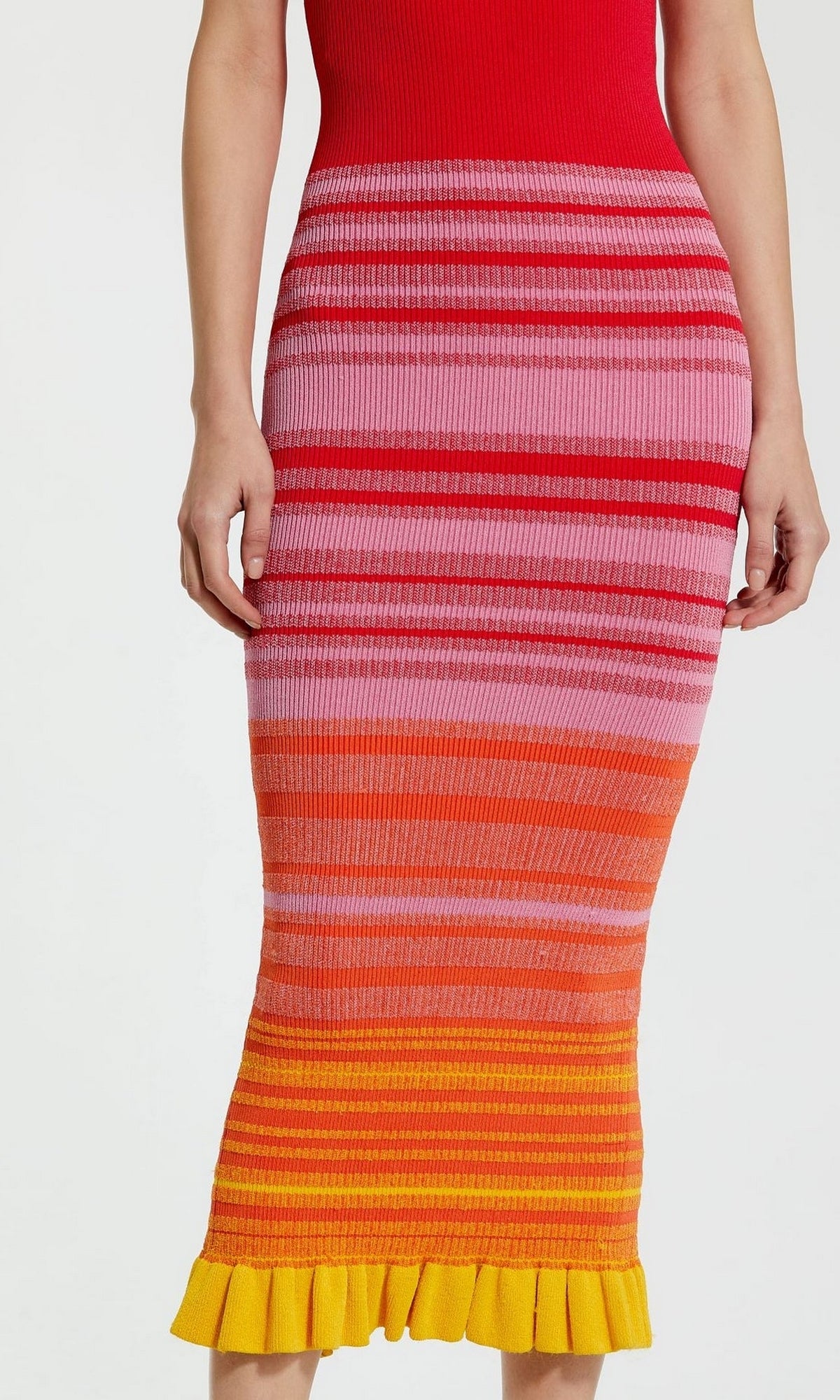 A person wearing the Mac Duggal Red Casual Wedding-Guest Dress K12007, a ribbed tank dress with multicolored horizontal pink, red, orange, and yellow stripes and a ruffled yellow hem.