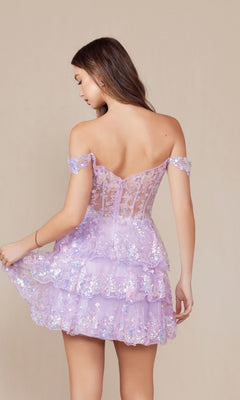A woman faces away wearing the Off-Shoulder Short Ruffled Sequin Hoco Dress K856, a lilac gown featuring floral lace, ruffles, and sequin details, while holding one side of its layered skirt.
