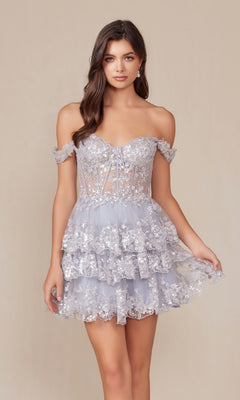 A woman stands against a beige background wearing the Off-Shoulder Short Ruffled Sequin Hoco Dress K856 in light purple, featuring floral lace and a tiered ruffled skirt that exudes effortless charm and style.