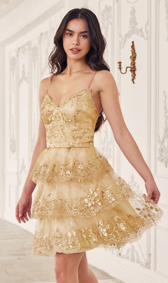A woman in the Sequin-Print Short Ruffled Homecoming Dress KV1090 stands in an ornate white room with decorative wall panels and a gold sconce.